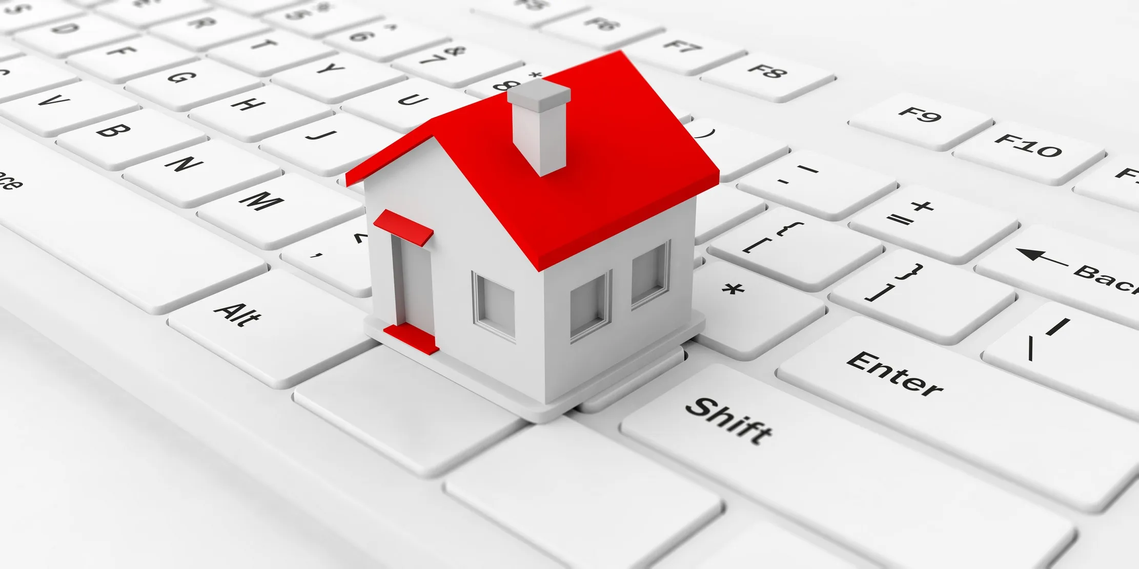 A single house model resting on a keyboard, representing one property record linked to its owner, tenant, and lease document
